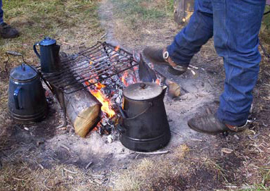 Camp fire and the black kettle of coffee